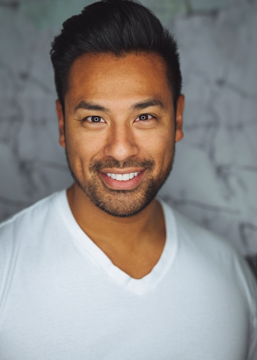 Young man smiling with bright background